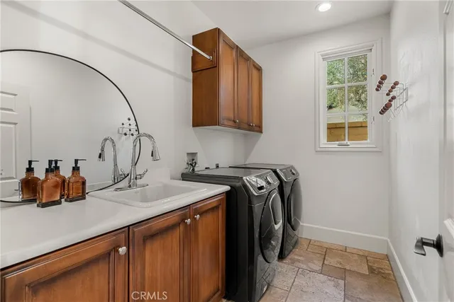 a utility room with sink dryer and washer