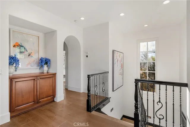 a view of a hallway with furniture and windows