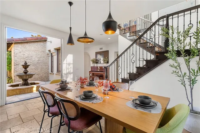 a dining room with furniture and a floor to ceiling window