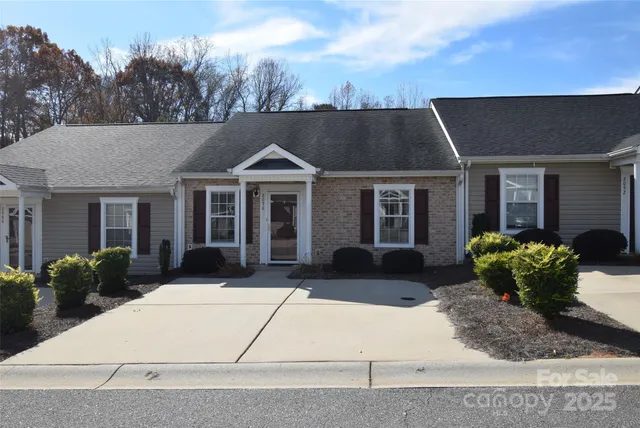 a front view of a house with a garden and plants