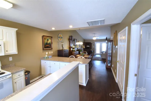 a view of a kitchen with a sink stainless steel appliances cabinets and a window