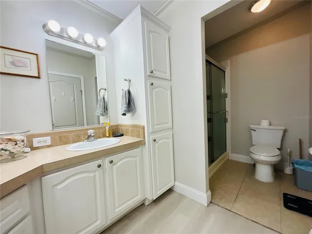 a spacious bathroom with a toilet sink and mirror