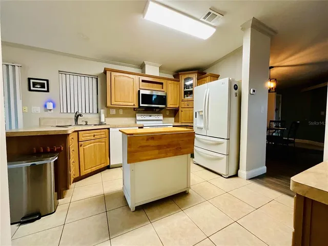 a kitchen with a stove sink and refrigerator
