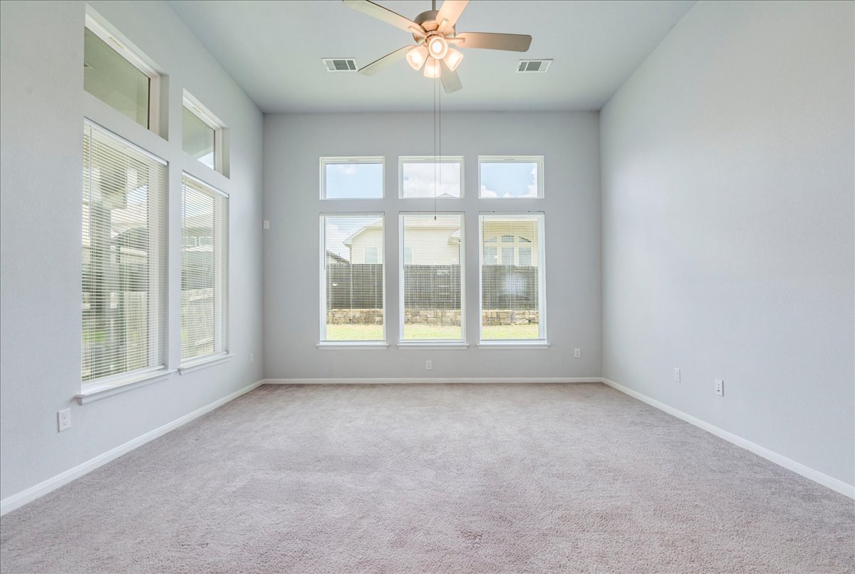 275 Cherrystone Loop Buda, TX 78610 - Photo 13 of 33 Living area with large windows