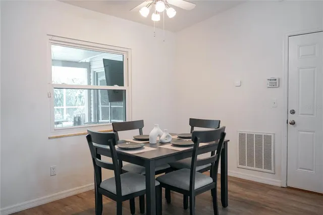 a view of a dining room with furniture window and wooden floor