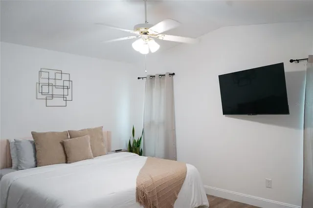 a bedroom with a bed and a flat screen tv