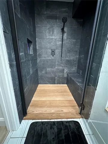 a bathroom with a bathtub and shower