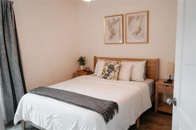 a bedroom with a bed and wall painting