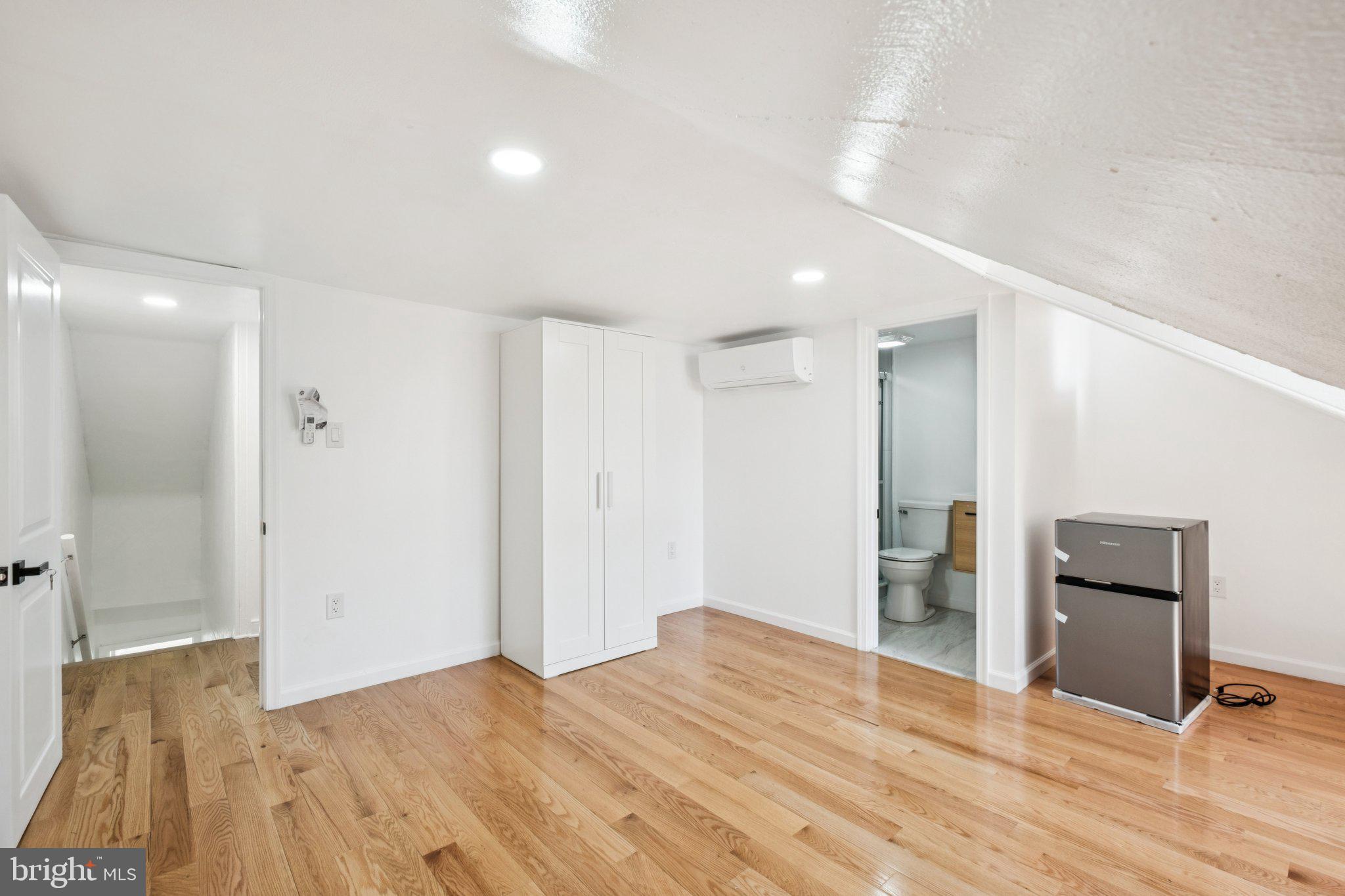 1223 Spruce Street, Unit 3F Philadelphia, PA 19107 - Photo 29 of 37 a big room with wooden floor and bathroom view