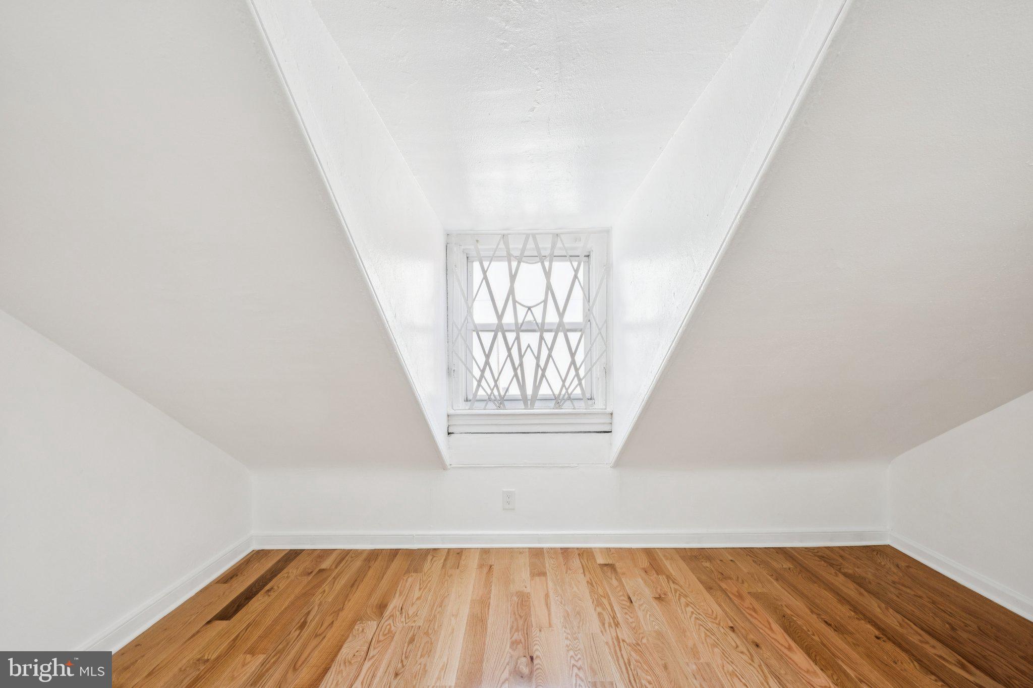 1223 Spruce Street, Unit 3F Philadelphia, PA 19107 - Photo 34 of 37 an empty room with wooden floor and windows