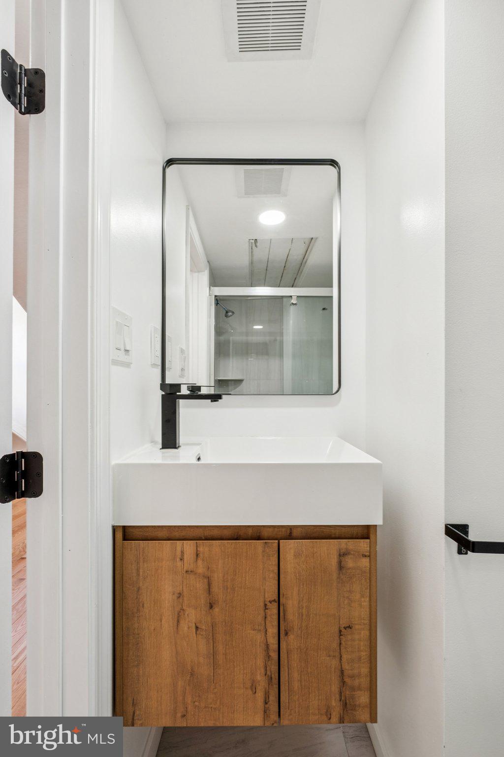 1223 Spruce Street, Unit 3F Philadelphia, PA 19107 - Photo 36 of 37 a bathroom with a sink and a mirror
