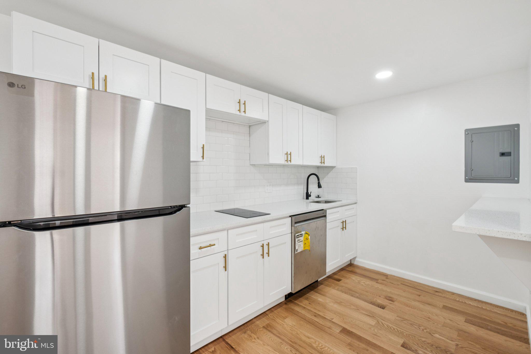 1223 Spruce Street, Unit 3F Philadelphia, PA 19107 - Photo 6 of 37 a kitchen with stainless steel appliances a refrigerator sink and cabinets