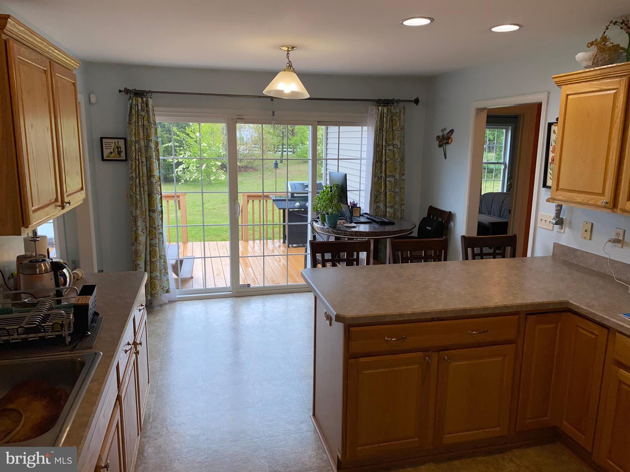 Kitchen with sliding glass door to large deck