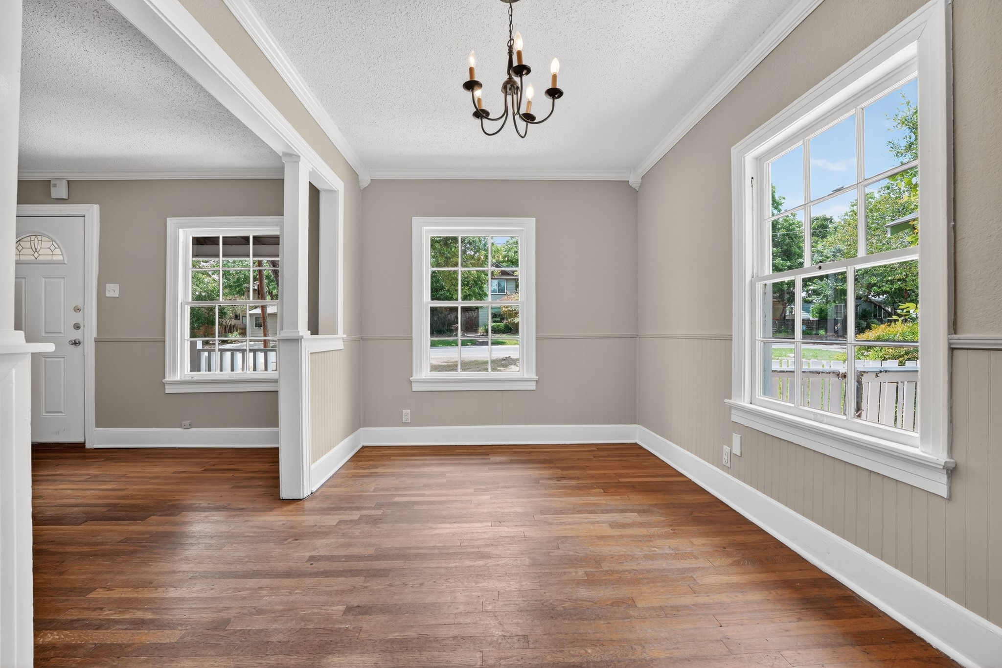 4907 Duval Street Austin, TX 78751 - Photo 4 of 31 a view of an empty room with wooden floor and a window