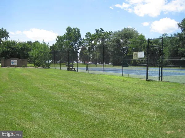 a view of a lake with a table and chairs