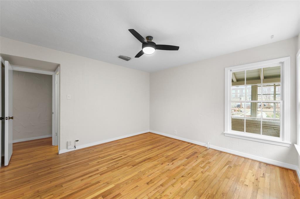 311 North Tennant Street Dallas, TX 75208 - Photo 11 of 23 a view of empty room with wooden floor and fan