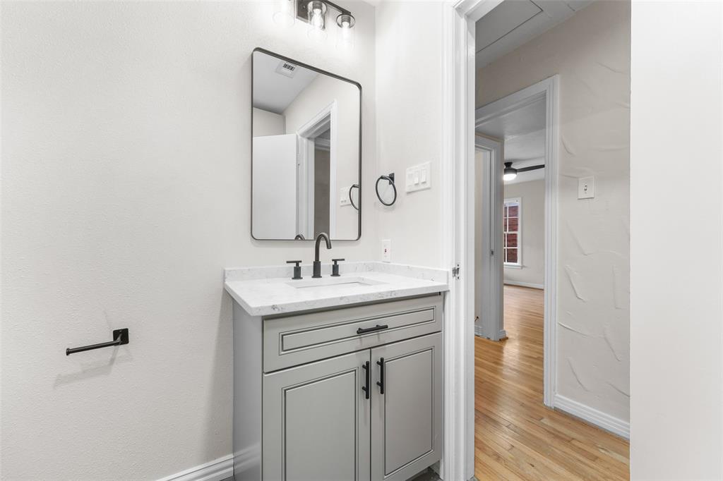 311 North Tennant Street Dallas, TX 75208 - Photo 13 of 23 a bathroom with a sink and a mirror