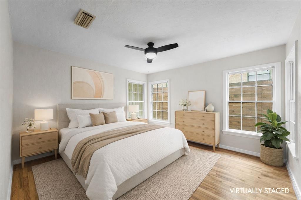 311 North Tennant Street Dallas, TX 75208 - Photo 16 of 23 a bedroom with a large bed potted plant and a window