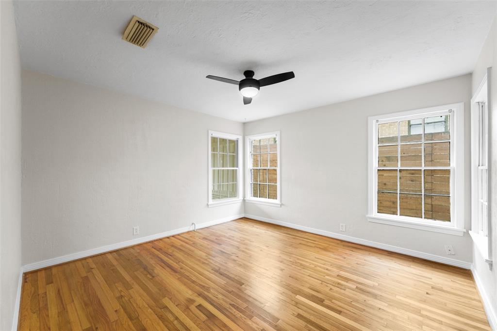 311 North Tennant Street Dallas, TX 75208 - Photo 17 of 23 a view of empty room with wooden floor and fan