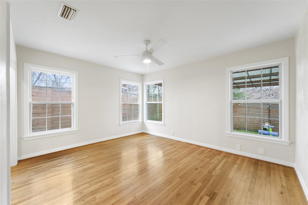 311 North Tennant Street Dallas, TX 75208 - Photo 19 of 23 an empty room with wooden floor and windows