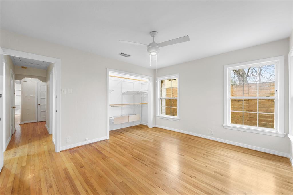 311 North Tennant Street Dallas, TX 75208 - Photo 20 of 23 an empty room with wooden floor and windows