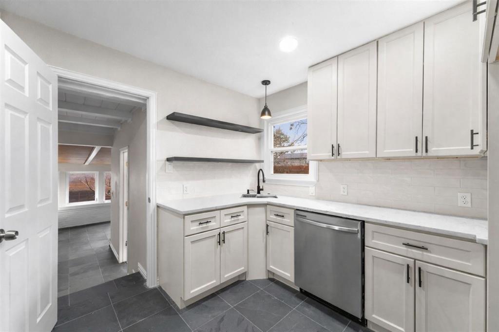 311 North Tennant Street Dallas, TX 75208 - Photo 3 of 23 a kitchen with a sink and cabinets
