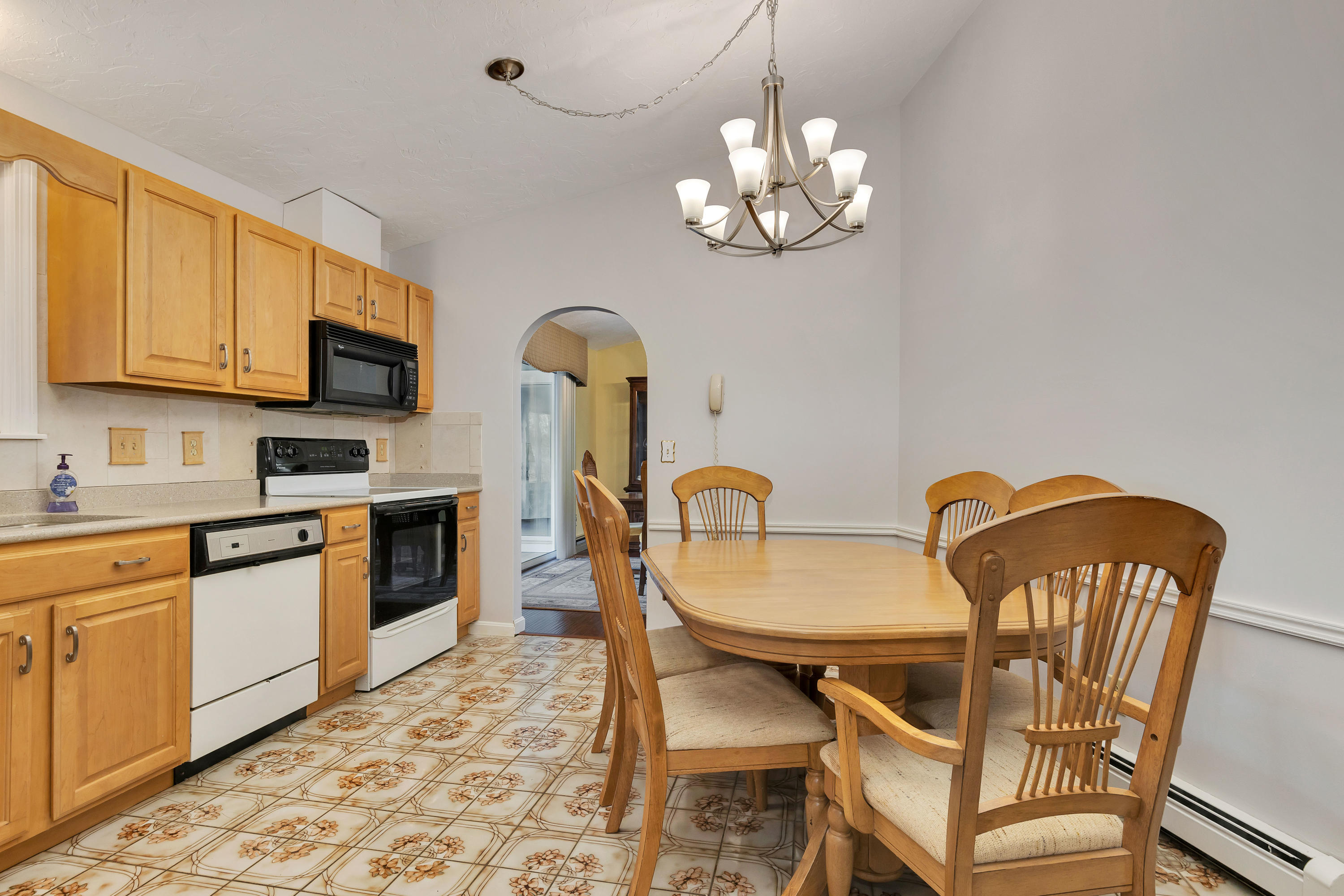 140 Thistle Drive Centerville, MA 02632 - Photo 15 of 46 a kitchen with stainless steel appliances granite countertop a dining table chairs and a refrigerator