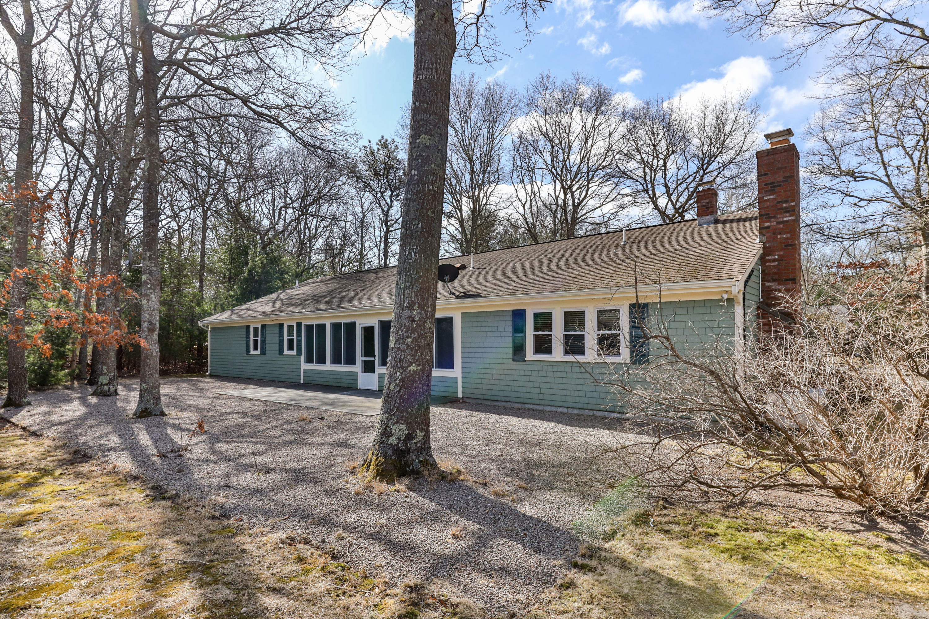 140 Thistle Drive Centerville, MA 02632 - Photo 40 of 46 a front view of house with yard and trees in the background