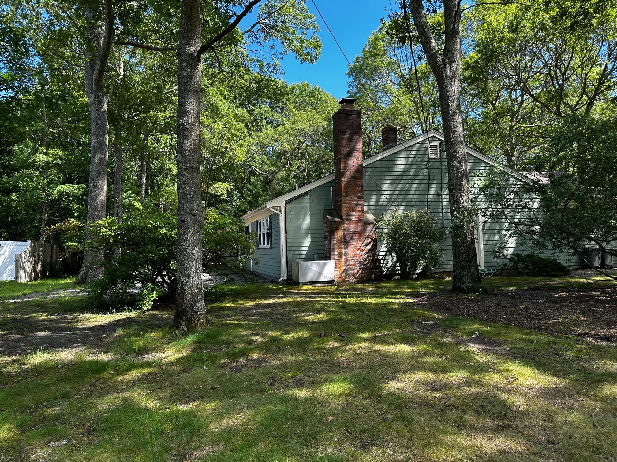 140 Thistle Drive Centerville, MA 02632 - Photo 42 of 46 a view of a trees in front of a house