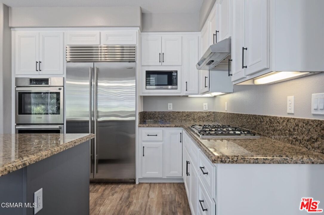 335 Kitetail Street Simi Valley, CA 93065 - Photo 12 of 37 a kitchen with stainless steel appliances granite countertop a sink and a stove