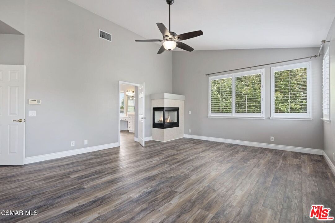 335 Kitetail Street Simi Valley, CA 93065 - Photo 18 of 37 a view of an empty room with wooden floor and a window