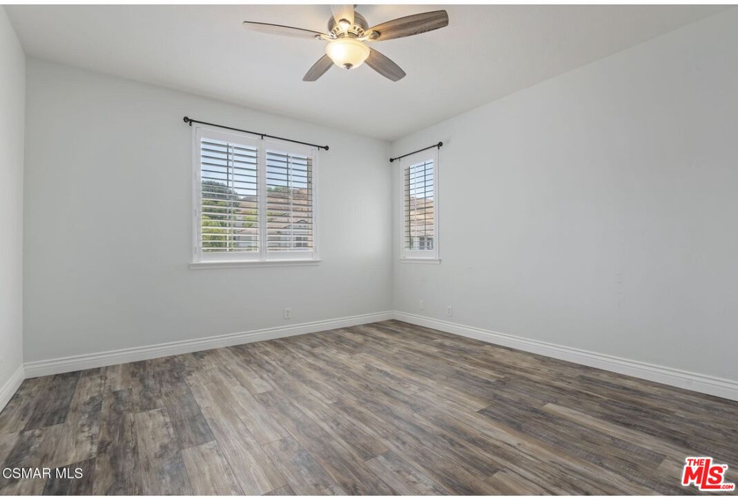 335 Kitetail Street Simi Valley, CA 93065 - Photo 26 of 37 a view of an empty room with wooden floor and a window
