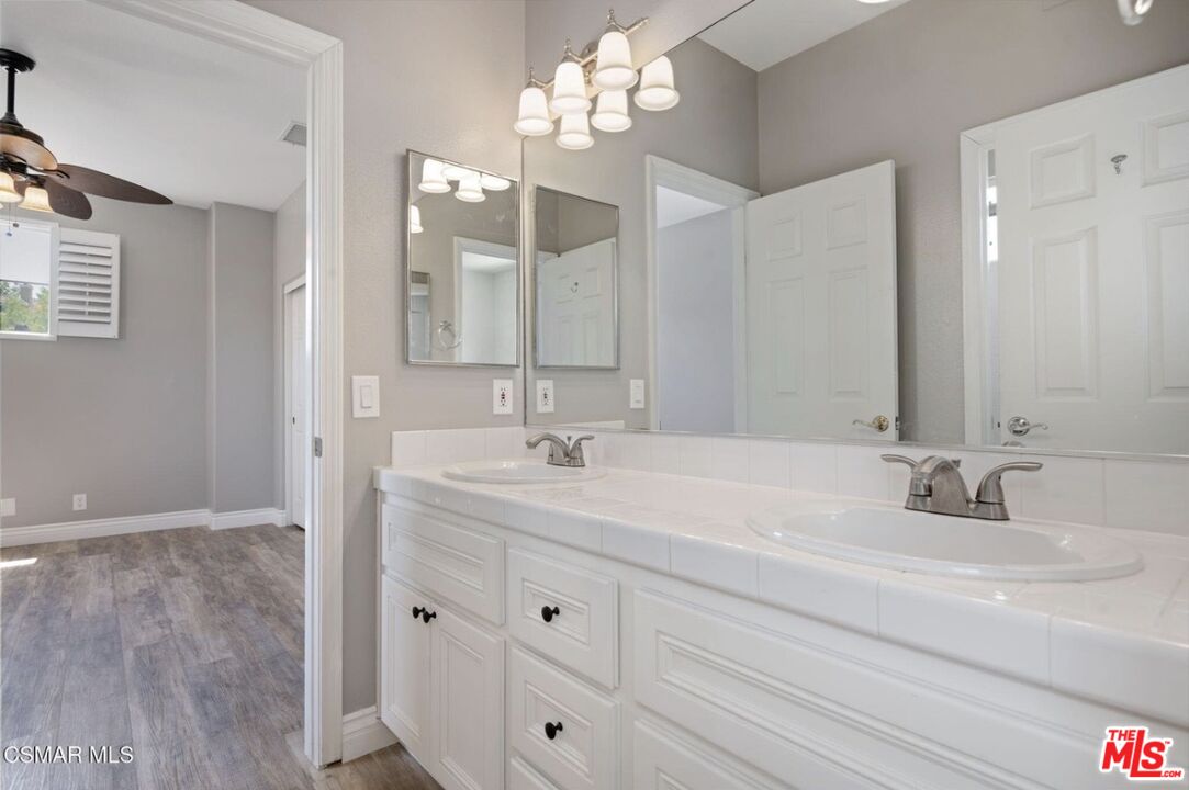 335 Kitetail Street Simi Valley, CA 93065 - Photo 29 of 37 a bathroom with double vanity sink a vanity and mirrors
