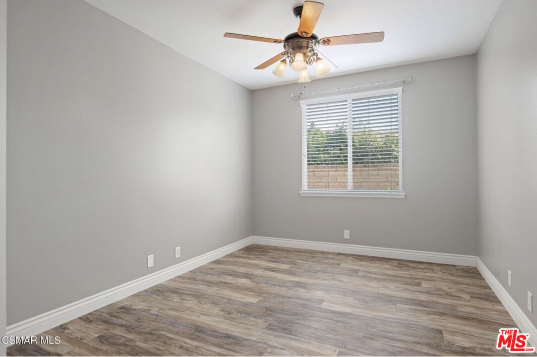 335 Kitetail Street Simi Valley, CA 93065 - Photo 31 of 37 a view of an empty room with wooden floor and a window