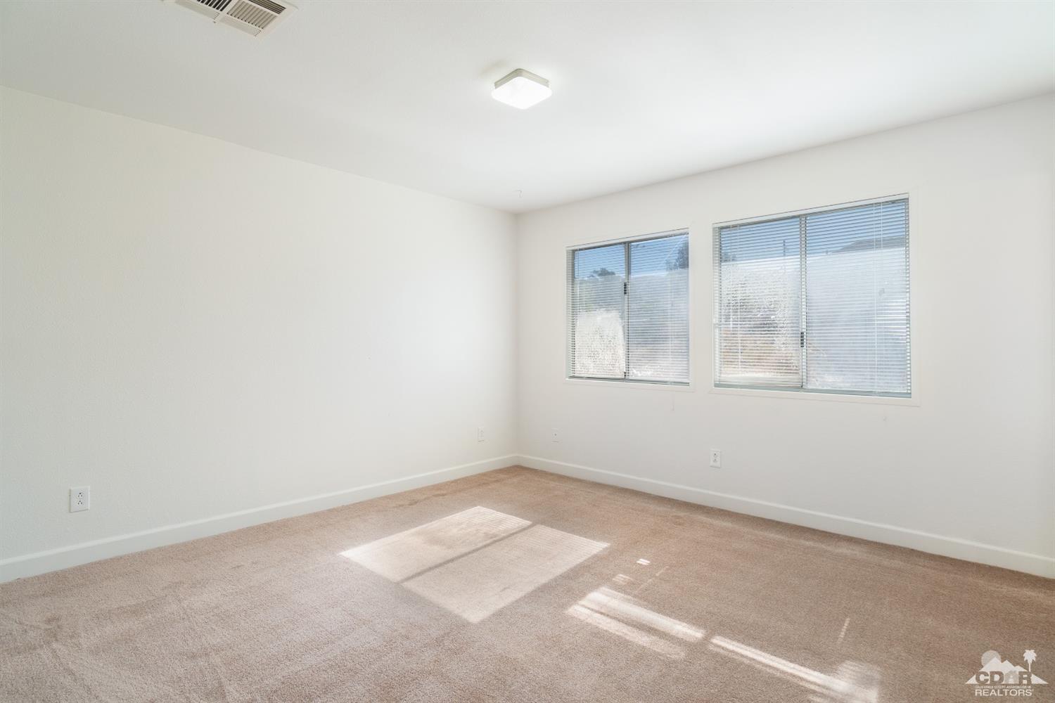 66186 Santa Rosa Road Desert Hot Springs, CA 92240 - Photo 11 of 23 an empty room with a window