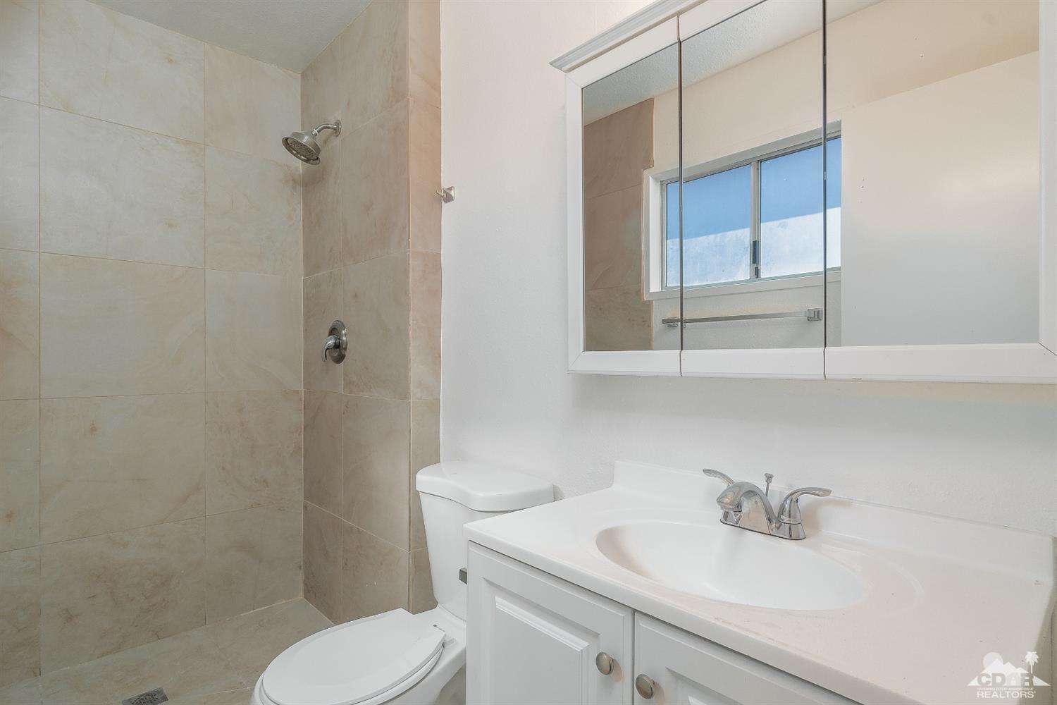 66186 Santa Rosa Road Desert Hot Springs, CA 92240 - Photo 14 of 23 a bathroom with a sink toilet and vanity