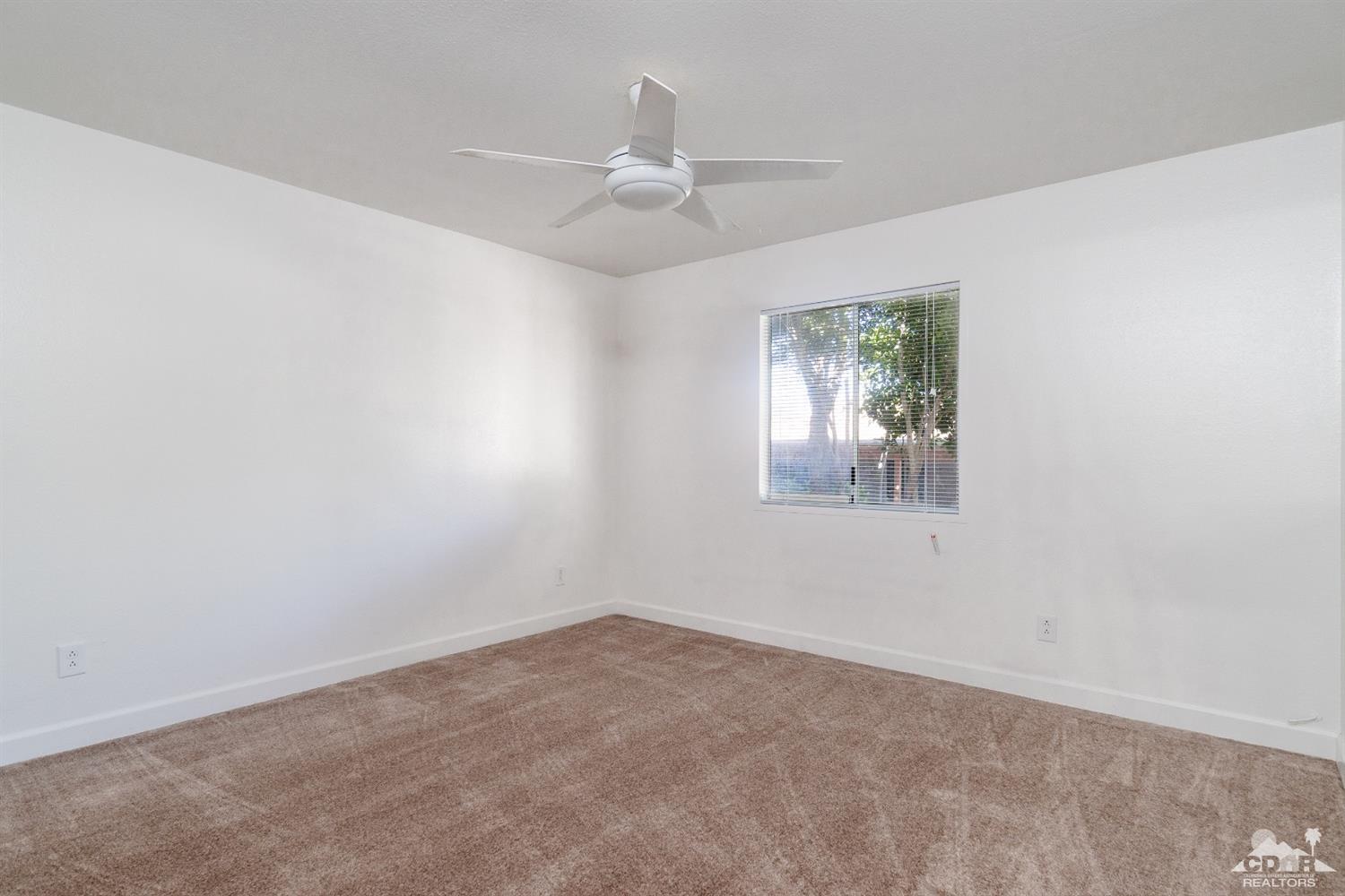 66186 Santa Rosa Road Desert Hot Springs, CA 92240 - Photo 17 of 23 an empty room with windows and fan