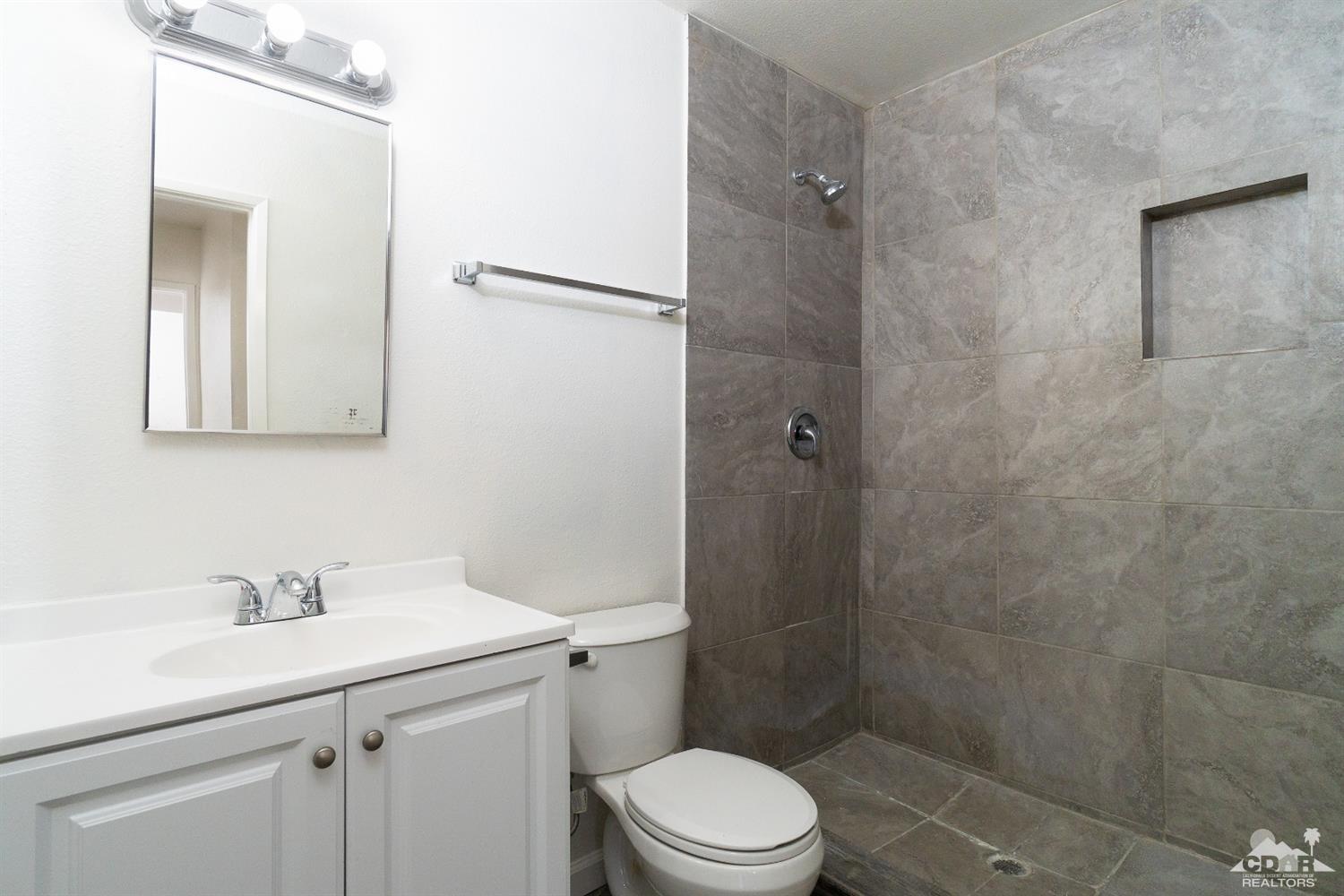 66186 Santa Rosa Road Desert Hot Springs, CA 92240 - Photo 10 of 23 a bathroom with a sink a toilet and shower
