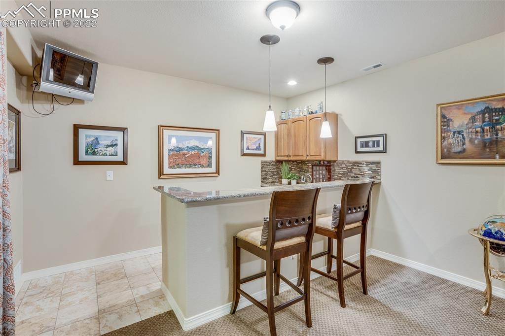 13214 Cake Bread Heights Colorado Springs, CO 80921 - Photo 19 of 28 a view of a kitchen area with furniture and chandelier