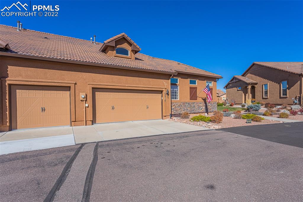 13214 Cake Bread Heights Colorado Springs, CO 80921 - Photo 4 of 28 a front view of a house with a yard and garage