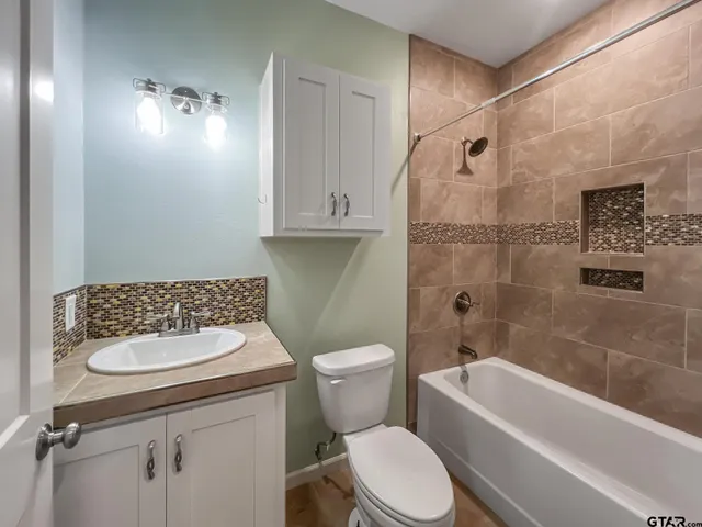 a bathroom with a toilet a sink and bathtub