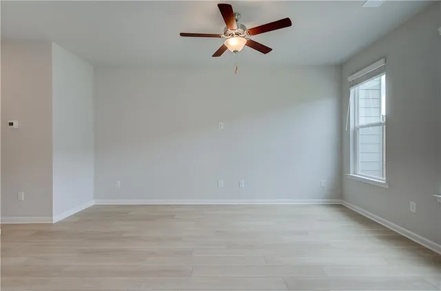 a kitchen that has a sink cabinets and wooden floor