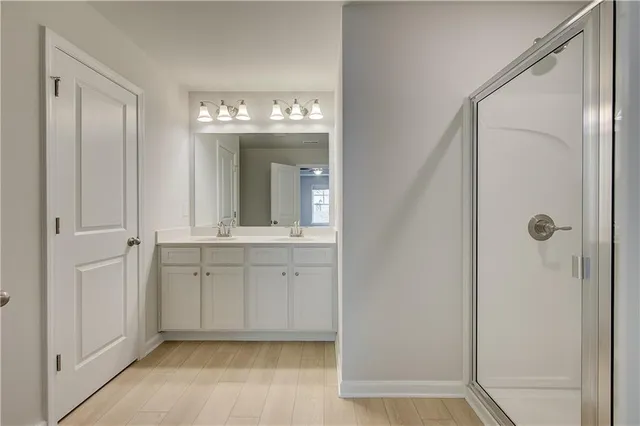a bathroom with a double vanity sink and mirror