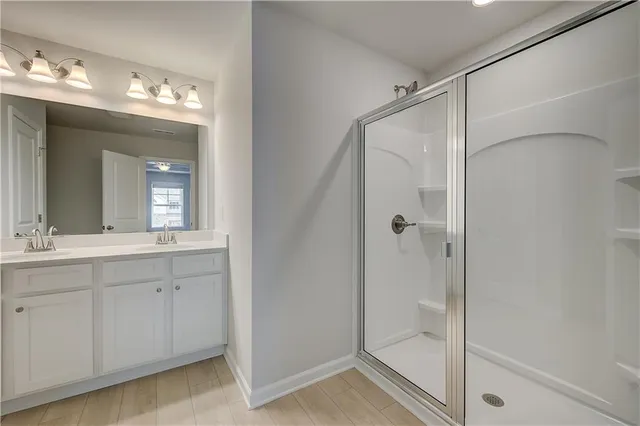 a bathroom with a double vanity sink and a mirror