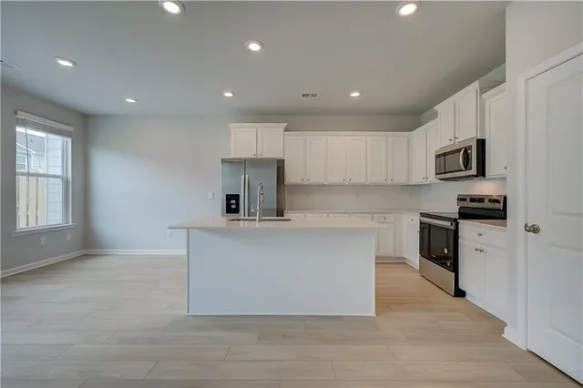 a view of kitchen with refrigerator sink and wooden floor