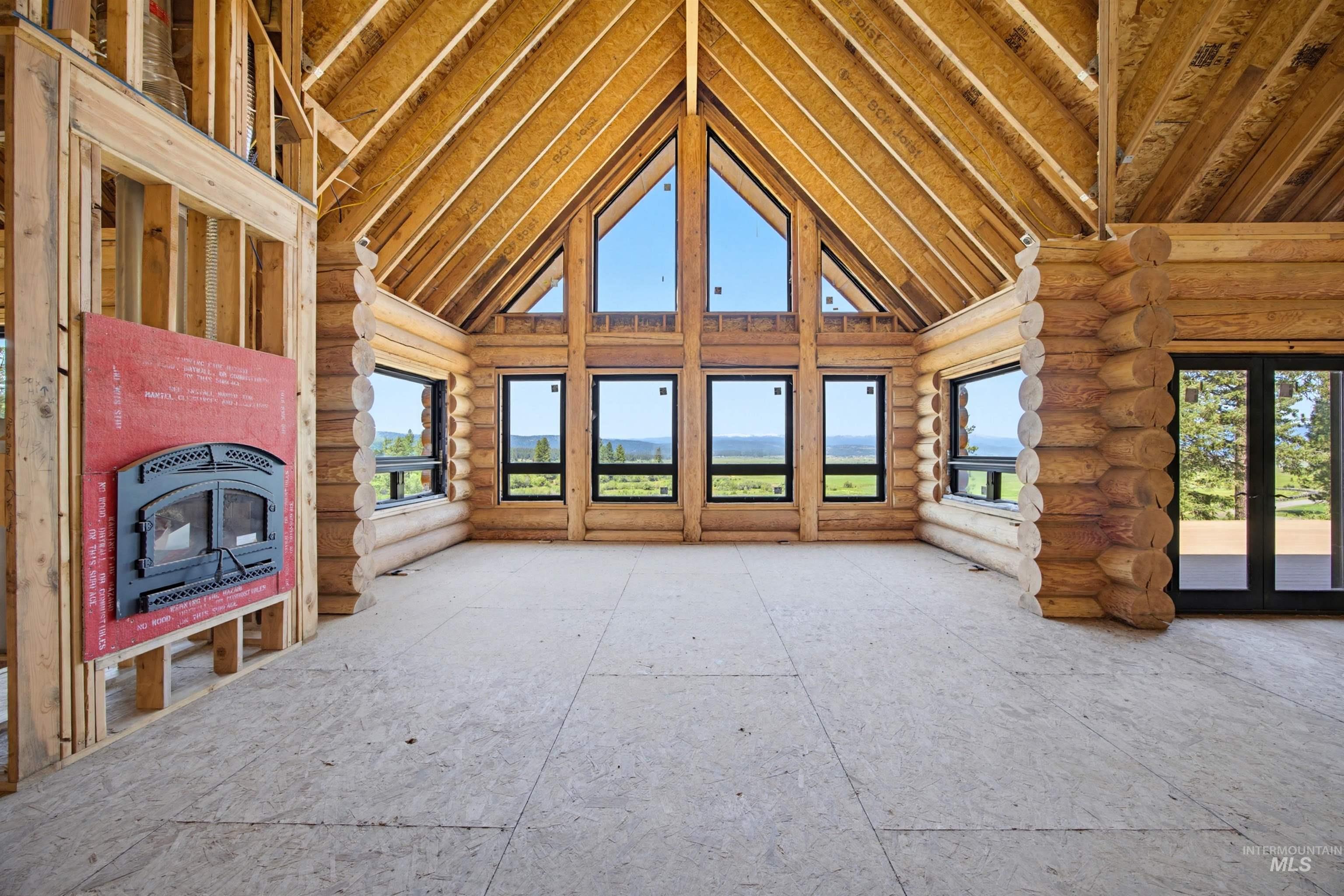 3322 Big Creek Road New Meadows, ID 83654 - Photo 21 of 50 Vaulted wood-plank ceilings above log walls and a fireplace insert
