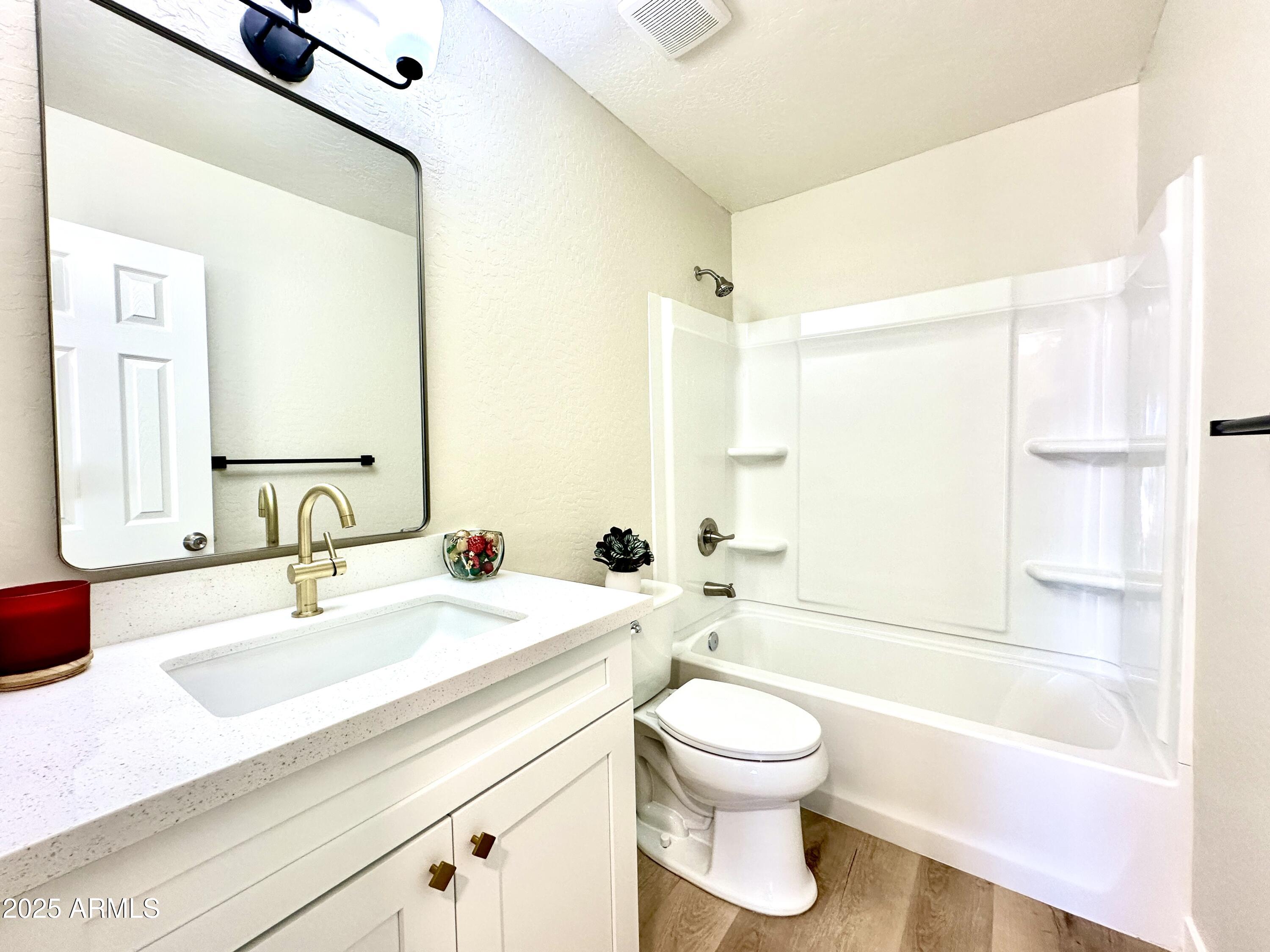 1188 North 4th Street Coolidge, AZ 85128 - Photo 13 of 26 a bathroom with a bathtub shower sink vanity mirror and toilet