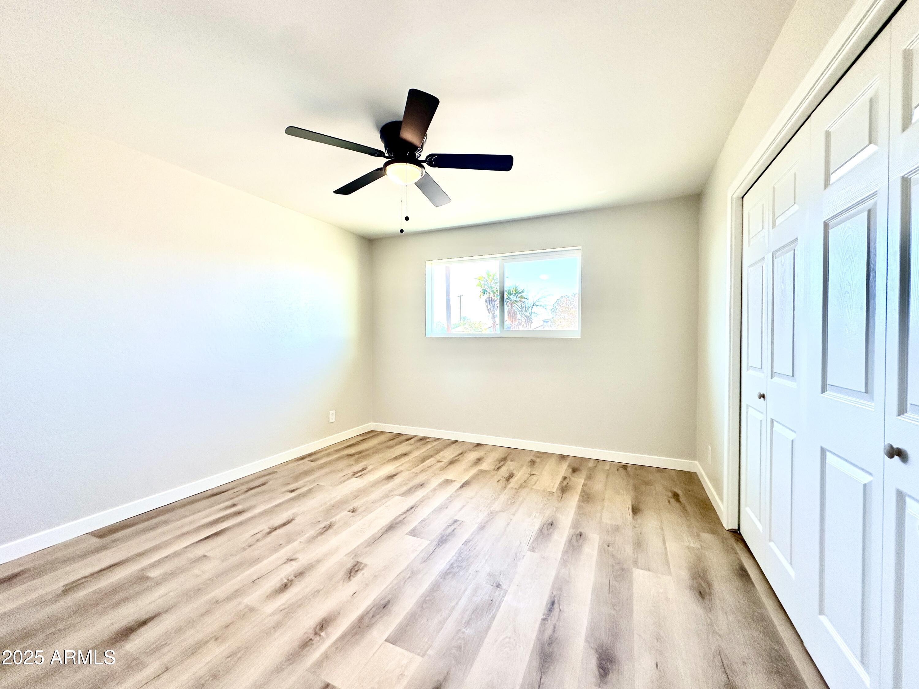 1188 North 4th Street Coolidge, AZ 85128 - Photo 15 of 26 a view of a big room with wooden floor and windows