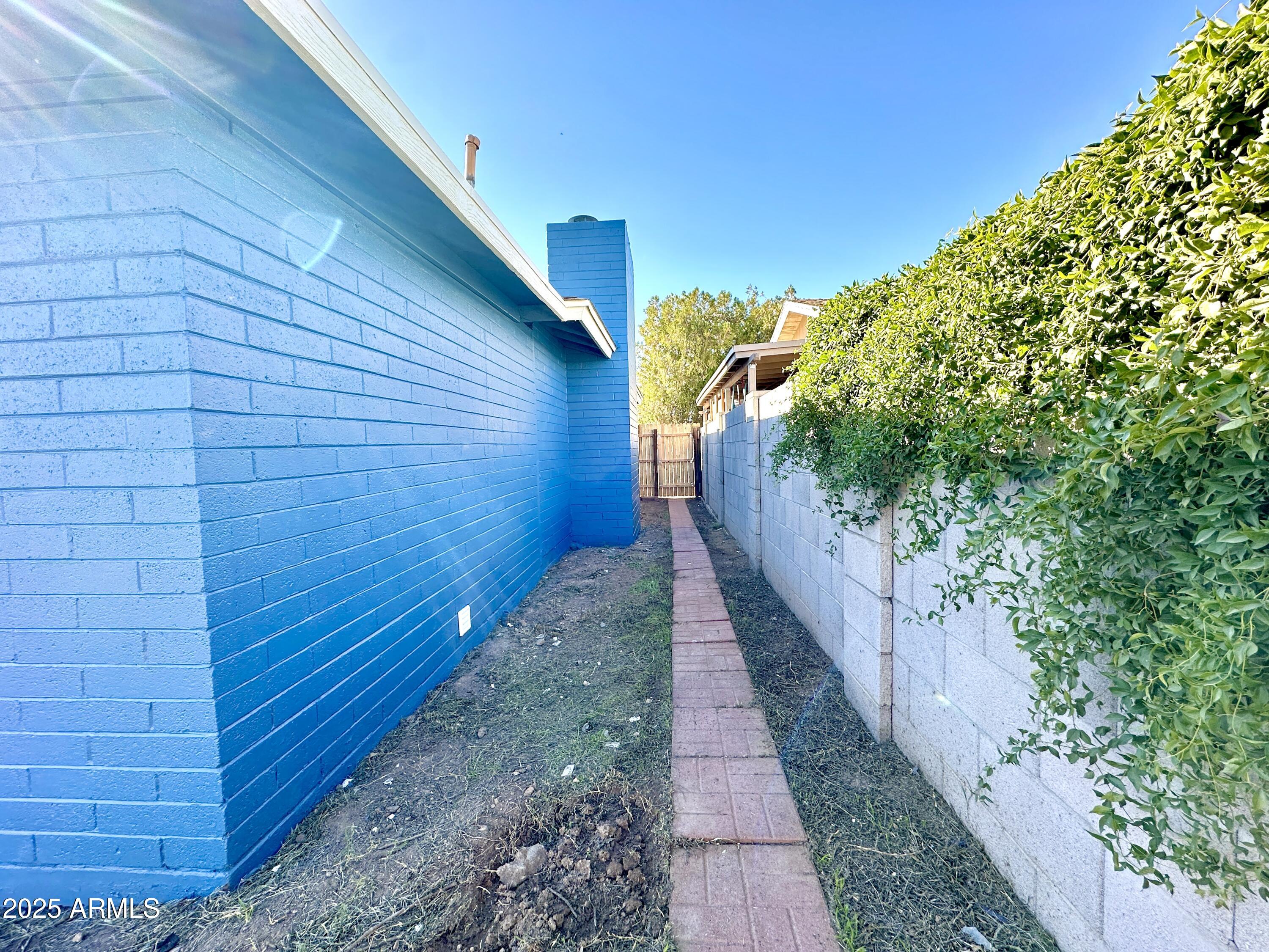 1188 North 4th Street Coolidge, AZ 85128 - Photo 18 of 26 a pathway of a house with a yard