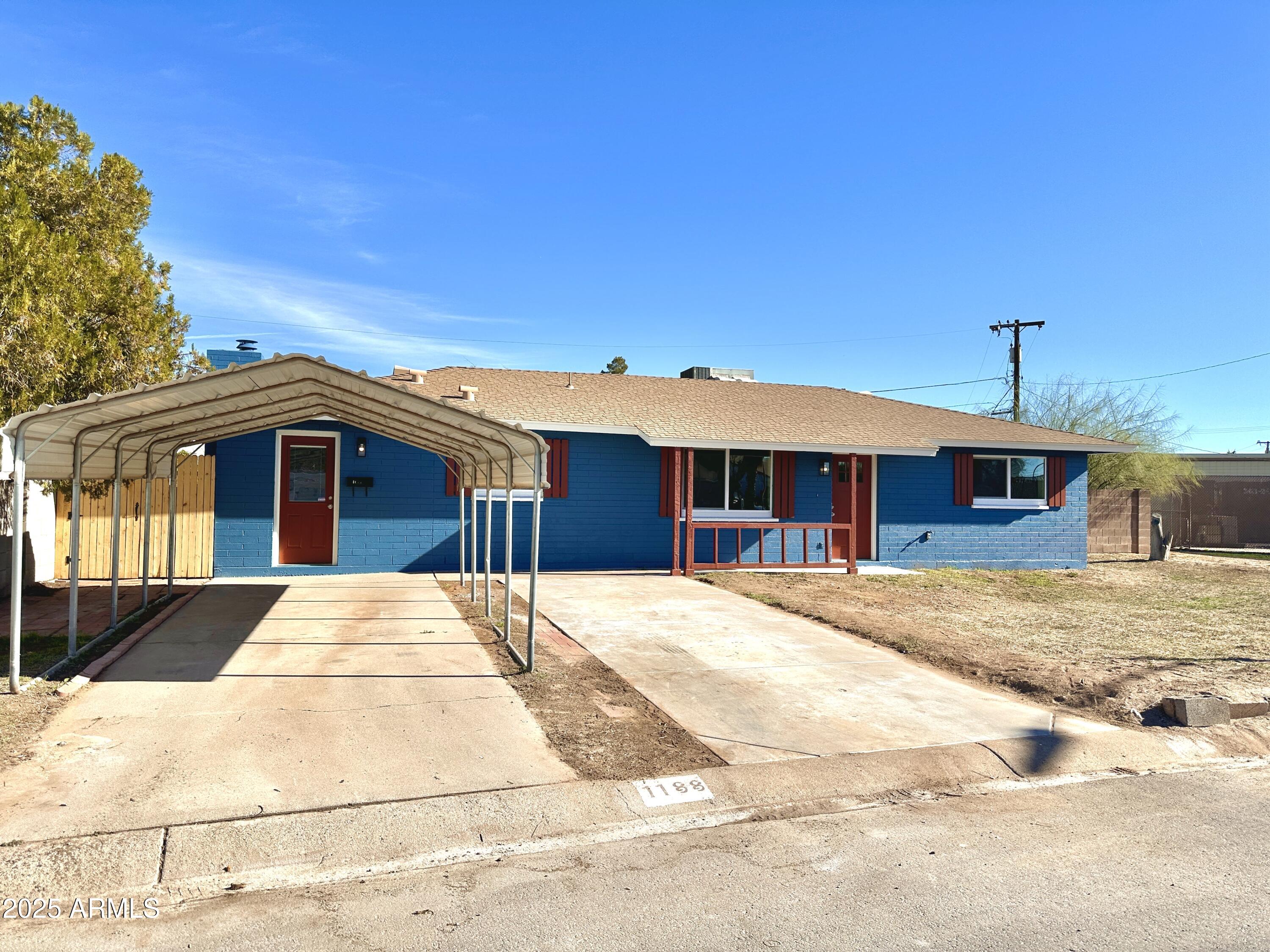 1188 North 4th Street Coolidge, AZ 85128 - Photo 2 of 26 a front view of a house with a yard